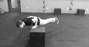 Train the one-arm one-leg push-up for a heavier military press