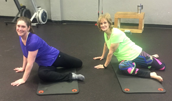 Tammy (on the right) practicing ground-based movements.