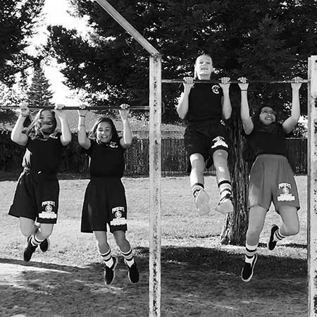 Young girls performing pullups
