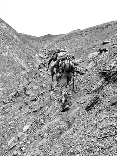 Men climbing a steep terrain