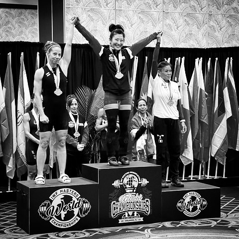 On Saturday, December 3rd Mira Kwon Gracia @getstrongwithmira, StrongFirst Certified Senior Instructor & StrongFirst Elite, accomplished her dream of becoming Master World Champion!

The IWF Master World Championships took place in Orlando, Florida. Based on qualifying totals and the attempt each lifter elected to take, Mira was the final lifter in the flight in both the snatch and the clean & jerk. Not only that, she took her opening attempts (her lightest ones) after each lifter had completed all three of their attempts (their heaviest ones). This meant that Mira just needed to make one snatch and one clean & jerk to secure the gold.

For the snatch, she opened at 54kg. She got the bar overhead and stood up with it, but the lift was turned down (2-to-1). She then repeated 54kg and made it, which secured her the win in the snatch. After that, she moved up to 56 and also completed it successfully.

For the clean and jerk, she opened at 69kg and made it – this lift won her both the clean & jerk and the overall gold medal! After that, she moved the bar up to 72kg and made it successfully, then finally to 73kg, where she cleaned it but missed the jerk.

Please help us congratulate coach Mira on this incredible achievement!

#strongfirst #bestrongfirst