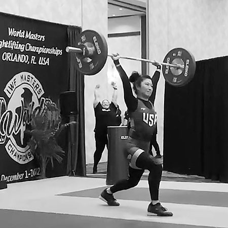 Mira performing the clean & jerk at the IWF Masters World Weightlifting Championships