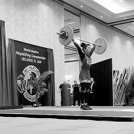 Mira performing the snatch at the IWF Masters World Weightlifting Championships